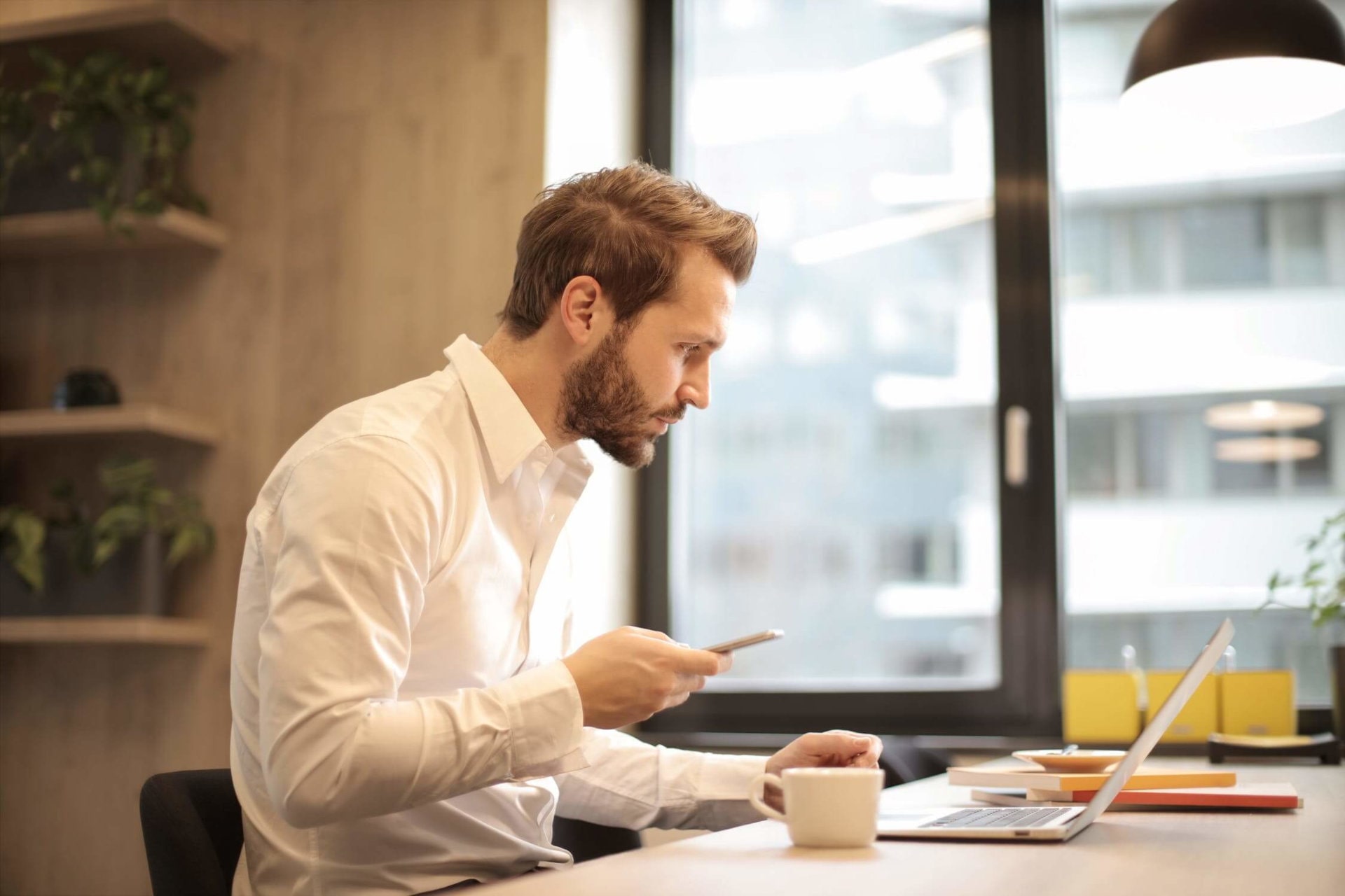 person working and drinking coffee